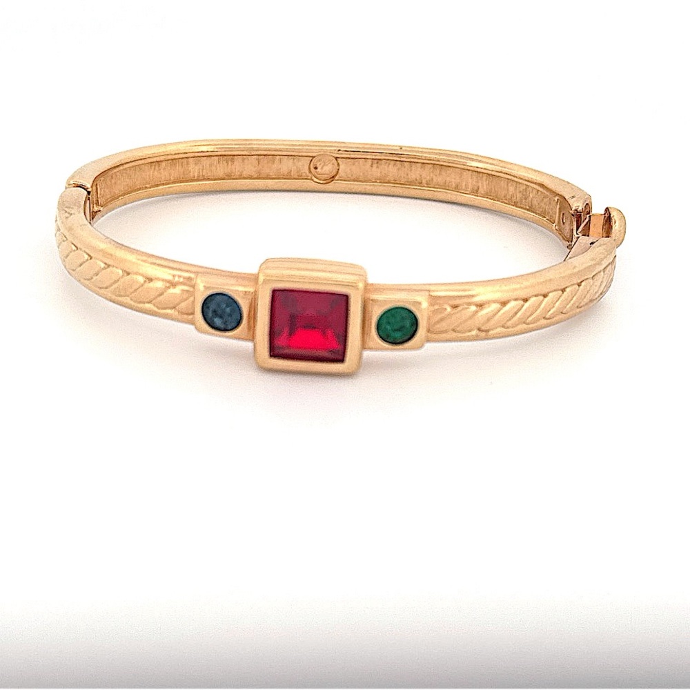 Swarovski gold tone hinged bracelet with ruby and emerald colored crystals